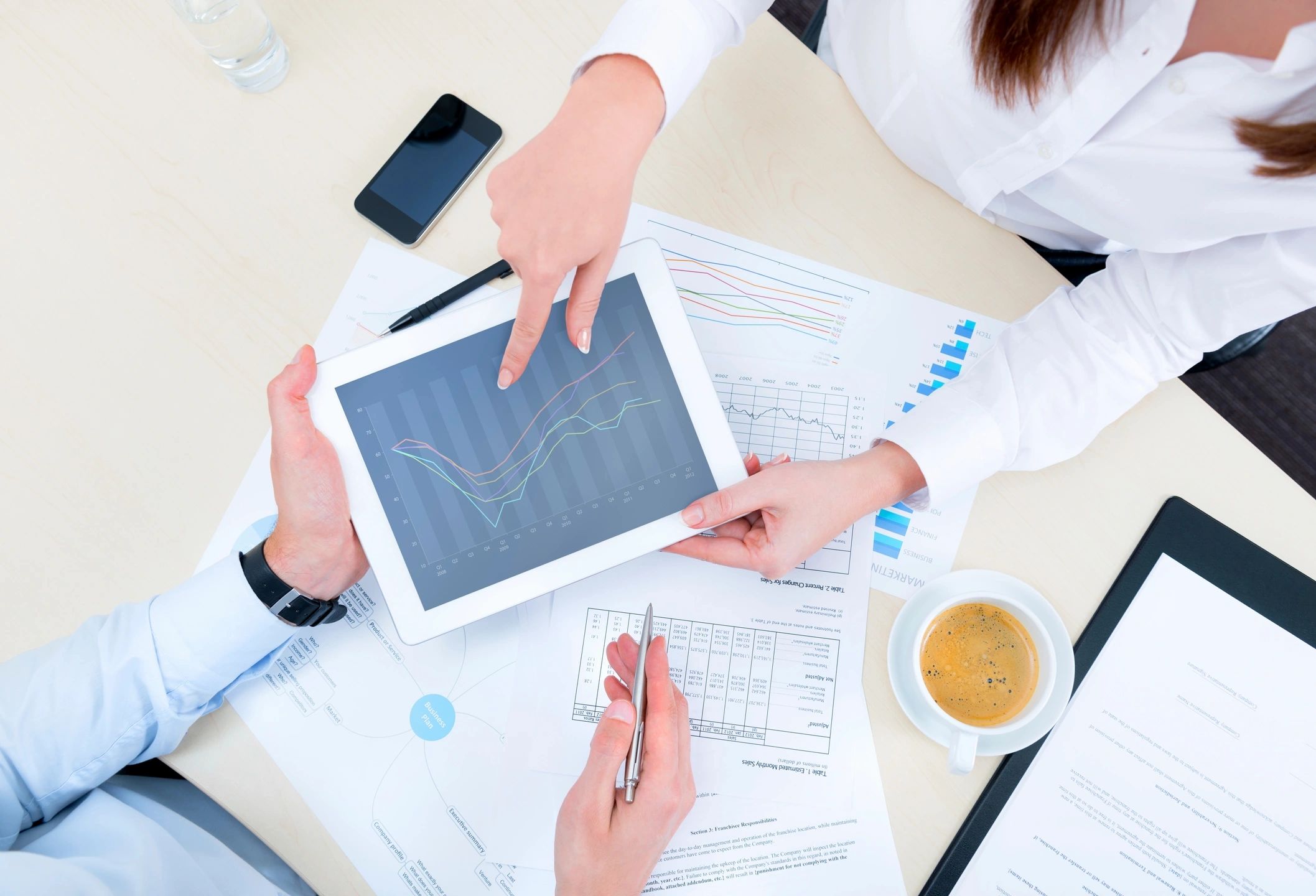 Woman and man looking at business analytics on a tablet